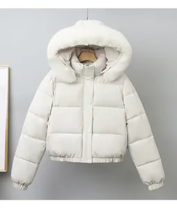 Short beige quilted puffer jacket for women featuring a large white faux fur hood trim