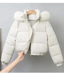 Detail view of white cropped puffer jacket featuring a fluffy faux fur collar and zipper