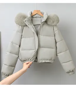 Detailed view of a light grey quilted jacket featuring a soft fur collar and zipper.