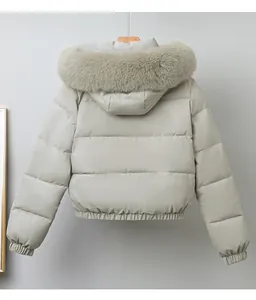 Back view of women's short padded jacket with a large faux fur collar in light sage green.