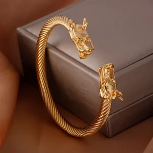 Elegant gold-plated stainless steel dragon head open cuff bracelet featuring a twisted wire band