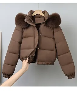 Close-up detail of a brown short puffer jacket featuring a large luxurious faux fur collar