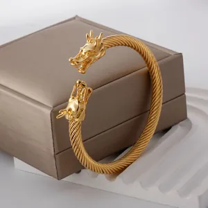 Punk style gold-plated stainless steel dragon head bangle with a twisted wire design