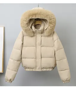 Front view detail of a beige short puffer jacket with a luxurious fluffy faux fur hood