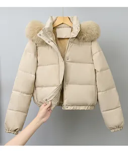 Close-up of a beige winter parka featuring a fluffy fur collar and warm plush lining detail