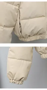Close-up of a beige puffer jacket featuring a side zipper pocket and elastic sleeve cuffs