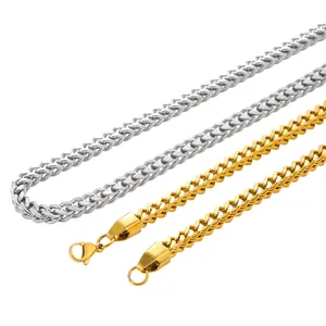 Close-up detail of gold and silver stainless steel Franco chains featuring a secure lobster clasp