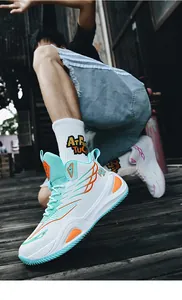 Detailed view of white high-top basketball shoes with teal accents on an active model