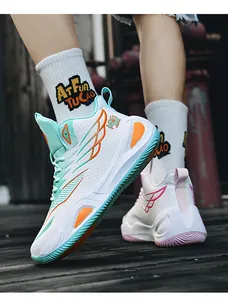 Detailed shot of mismatched high-top basketball shoes featuring a unique wing pattern design