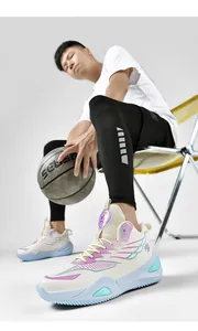 Detailed shot of mismatched high-top basketball shoes on a male model's feet