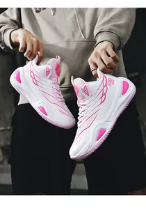 Close-up of men's high-top basketball shoes in white and pink with wing pattern