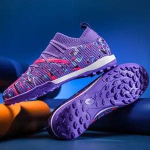 Purple soccer turf shoes with vibrant patterns and studded rubber soles for training