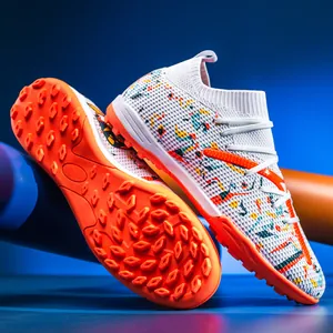 Detail of turf soccer shoes featuring textured outsole and colorful mesh upper