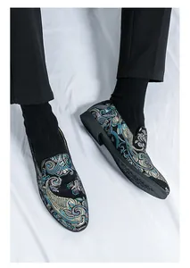 Detailaufnahme von Herren-Loafern mit aufwendiger blau-goldener Paisley-Stickerei.