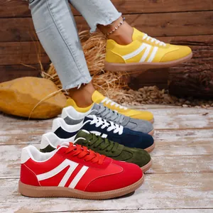 Collection of colorful retro casual sneakers for women on a rustic wooden background