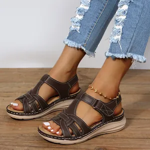 Comfortable brown women's platform sandals with cross-strap design and white stitching