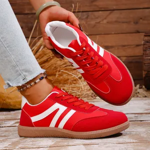 Detailed close-up view of stylish red and white retro casual sneakers for women