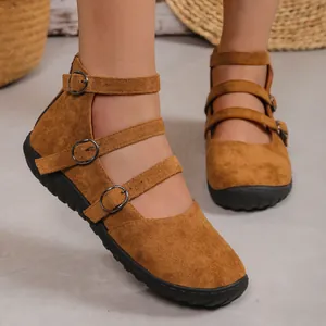 Detail of brown suede retro square toe shoes with triple buckle straps on model