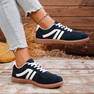 Side view of navy blue retro casual women's sneakers with stylish white stripes