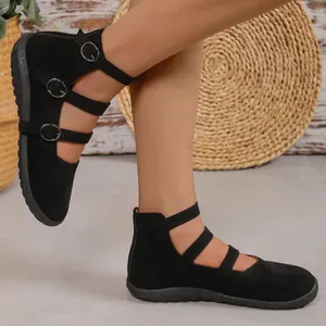Close-up detail of French vintage black suede flats with triple buckle straps and square toe.