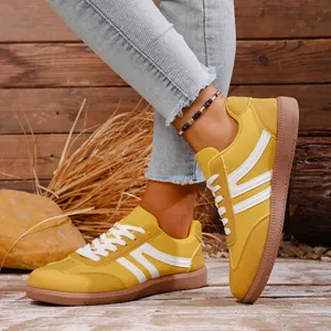 Retro yellow casual sneakers for women with white stripes and brown flat rubber soles