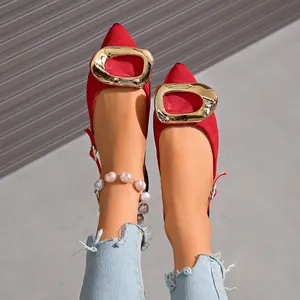 Detailed top view of red French style pointed-toe flat sandals with a large gold buckle