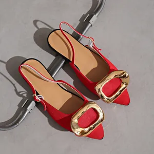Top-down view of red pointed-toe slingback flats featuring a decorative large gold buckle.