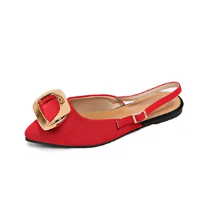 Close-up view of elegant red closed-toe slingback flats with decorative gold buckle