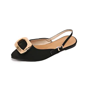 Detailed view of elegant black pointed toe flat slingback sandals with gold buckle