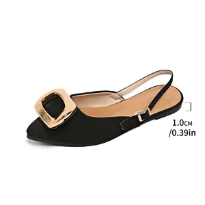 Side view detail of black French pointed-toe flat slingback sandals with a large gold buckle