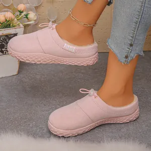 Detail of pink fleece-lined winter slippers showing plush interior and thick sole