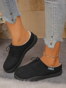 Detail view of black fleece-lined loafers with slip-on design and durable rubber sole