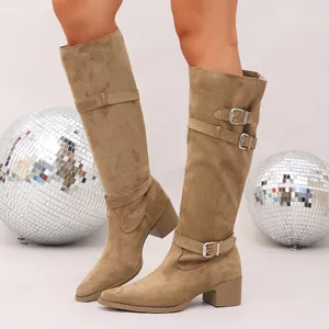 Detailed view of tan suede knee-high boots featuring stylish buckle straps and block heels