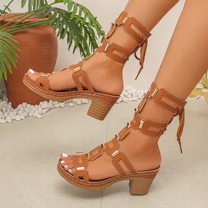 Detail view of brown chunky heel gladiator sandals with strappy lace-up design