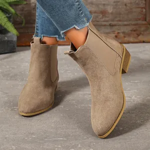 Stylish women's khaki suede pointed-toe Chelsea boots shown in a detail wearing shot