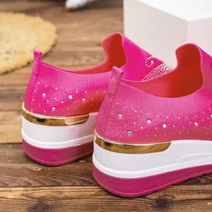 Macro detail of bright pink fly-weave platform shoes with sparkling rhinestone embellishments