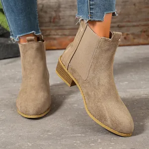 Detailed view of stylish khaki suede pointed toe Chelsea boots with a stable block heel.