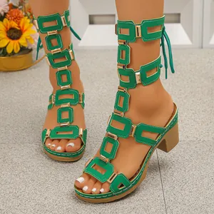 Detailed view of women's green lace-up block heel gladiator sandals worn by a model.