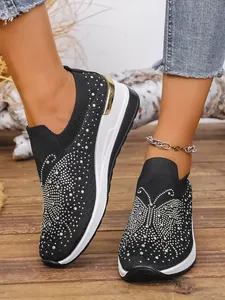 Black flying woven wedge sneakers featuring sparkling rhinestone butterfly patterns