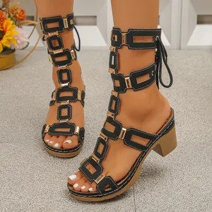 Stylish black lace-up peep-toe sandals for women with gold accents and chunky heels.