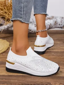 Stylish white fly-knit wedge sneakers for women featuring sparkly rhinestones and thick soles