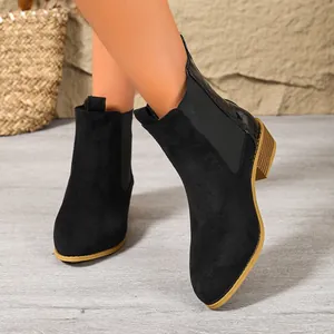 Stylish black suede pointed-toe Chelsea boots for women with textured heel detail
