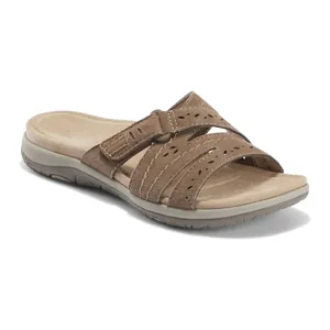 Detailed side view of a brown suede slide sandal with laser-cut floral patterns