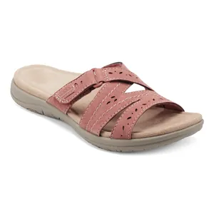 Detailed macro shot of women's pink platform sandals featuring laser-cut floral details