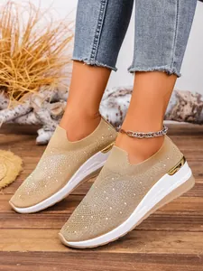 Close-up of rhinestone fly-knit wedge sneakers for women in a stylish lifestyle setting