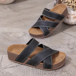 Stylish women's wedge sandals with black crossover straps and wood grain platform sole.
