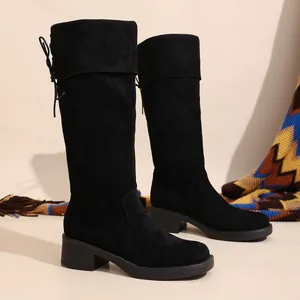 Elegant black suede knee-high boots with chunky heels for winter season