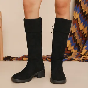 Front view of black suede knee-high boots with chunky heels and fold-over cuff