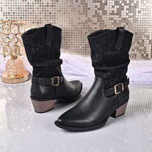 Detailed macro view of women's black mid-calf boots with leopard print and buckle strap