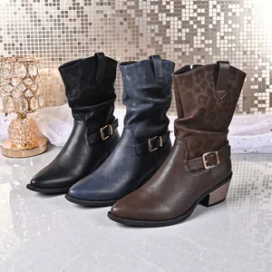 Close-up of stylish mid-calf boots in black, blue, and brown with side buckles.